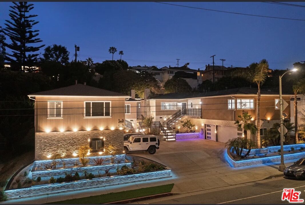 a front view of a house with outdoor seating