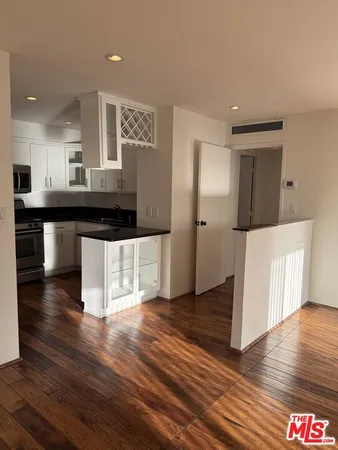 a kitchen with stainless steel appliances granite countertop a stove and a refrigerator