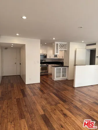 a view of kitchen with sink and refrigerator
