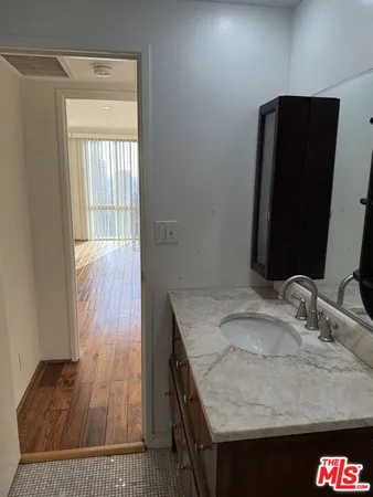 a view of empty room with wooden floor and windows