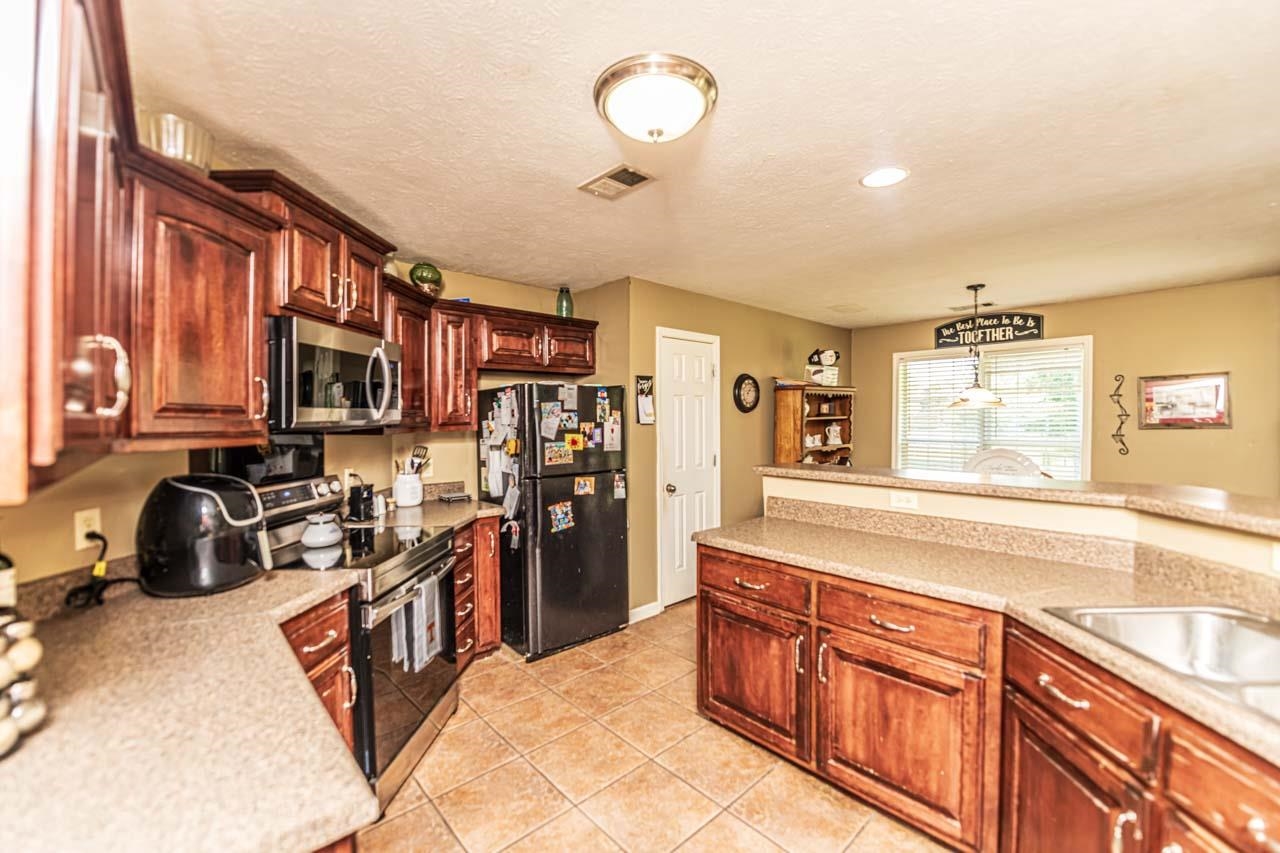 706 Liberty Church Smith Road Brighton, TN 38011 - Photo 13 of 35 a kitchen with stainless steel appliances granite countertop a refrigerator and a sink