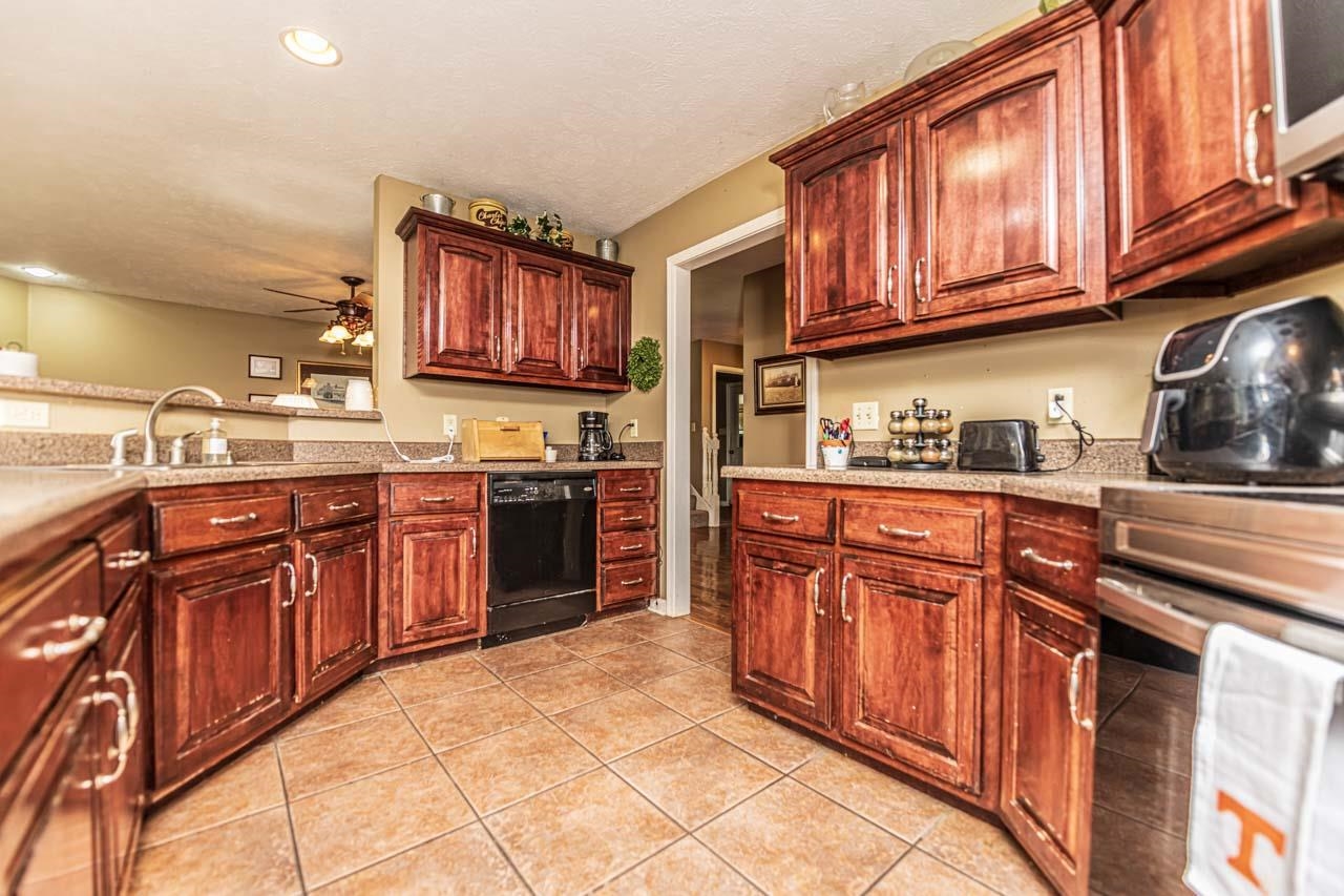 706 Liberty Church Smith Road Brighton, TN 38011 - Photo 16 of 35 a kitchen with stainless steel appliances granite countertop a stove sink and cabinets
