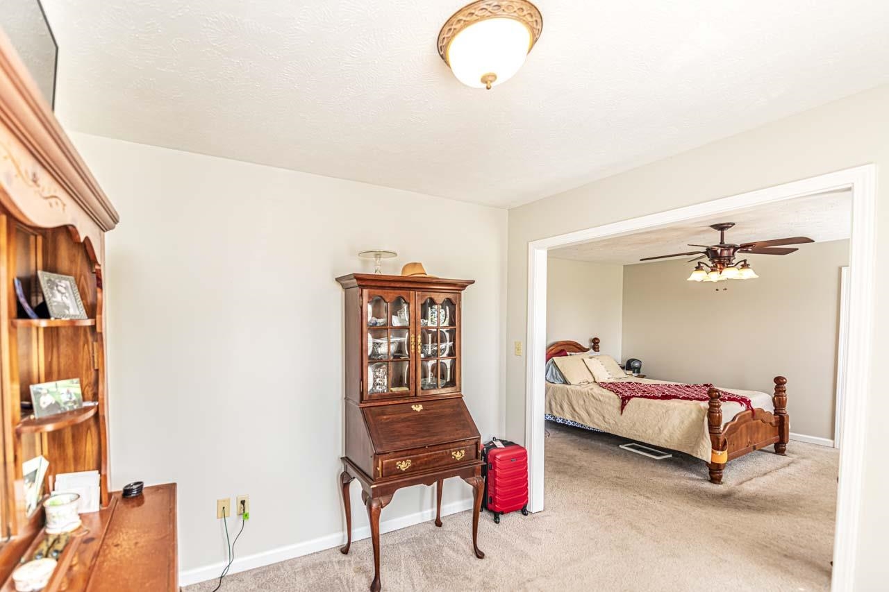 706 Liberty Church Smith Road Brighton, TN 38011 - Photo 21 of 35 a bedroom with bed and a chandelier