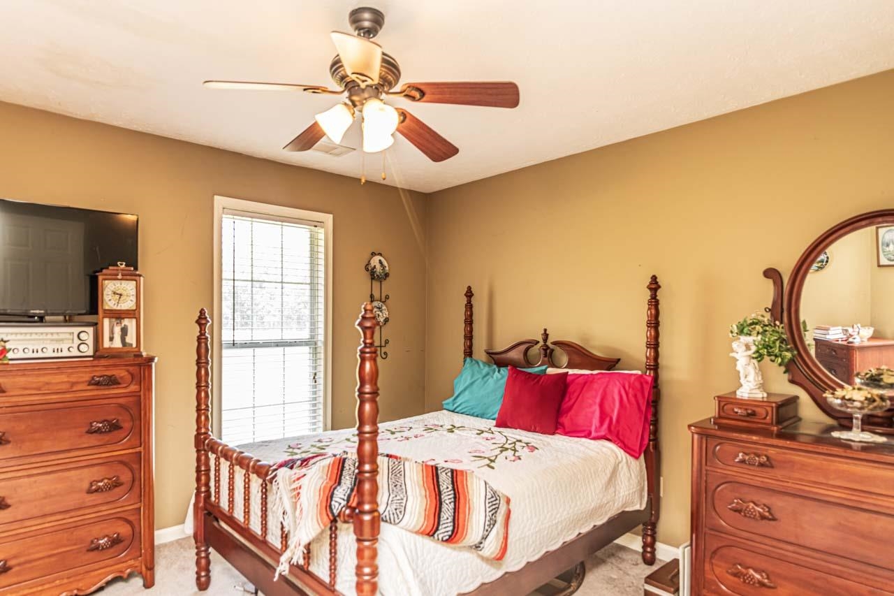 706 Liberty Church Smith Road Brighton, TN 38011 - Photo 25 of 35 a bedroom with a bed and wooden floor
