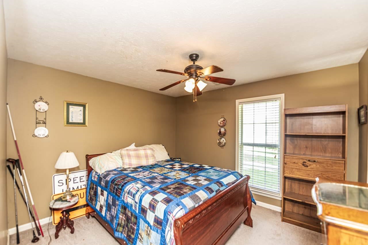 706 Liberty Church Smith Road Brighton, TN 38011 - Photo 27 of 35 a bedroom with a bed and a chandelier