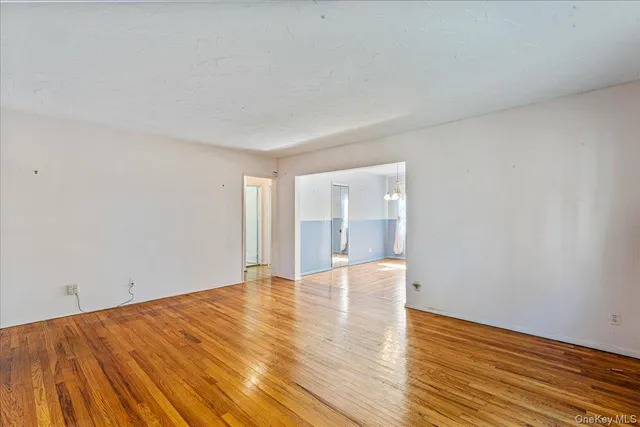 a view of an empty room and wooden floor