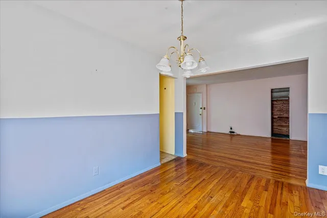a view of a room with wooden floor and natural light