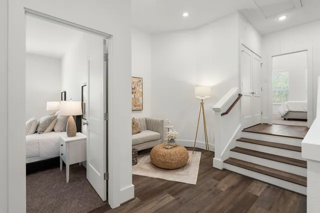 a bedroom with furniture and a wooden floor