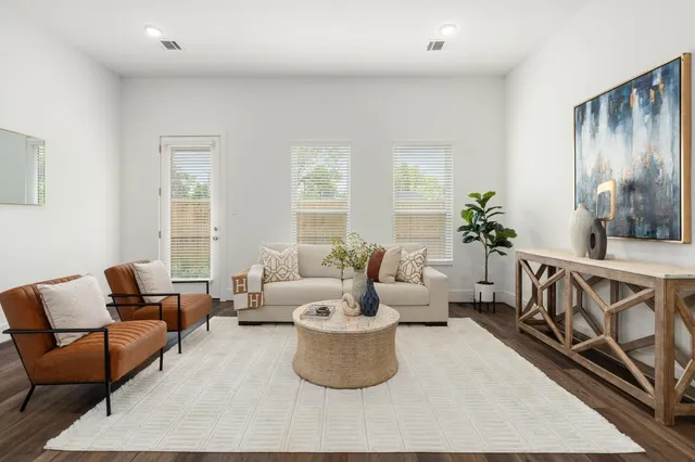 a living room with furniture and a potted plant