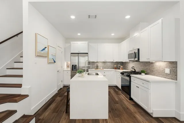 a kitchen with a sink a stove and refrigerator
