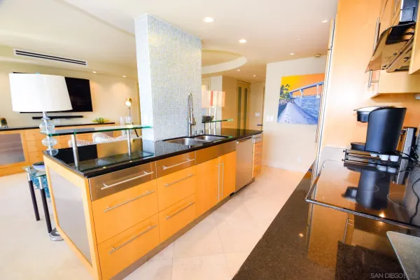 a kitchen with stainless steel appliances granite countertop a sink and a stove