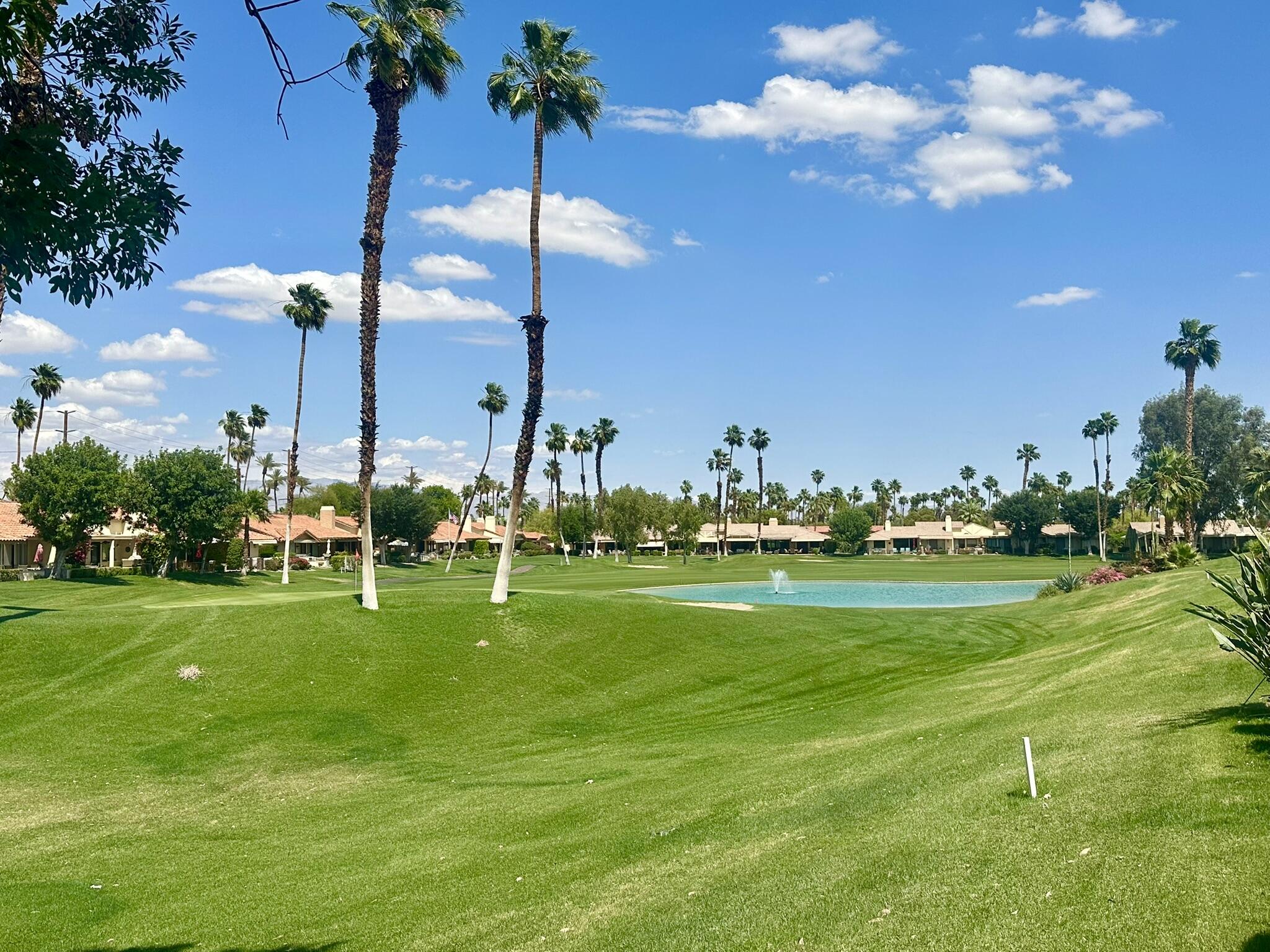 336 Villena Way Palm Desert, CA 92260 - Photo 1 of 19 a view of a golf course with a lake