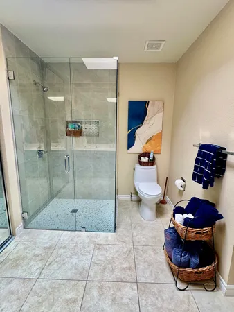 a bathroom with a toilet and a shower