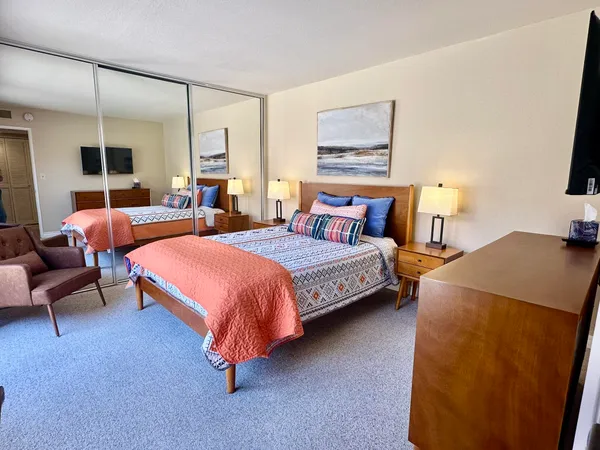 a bedroom with bed and a night stand
