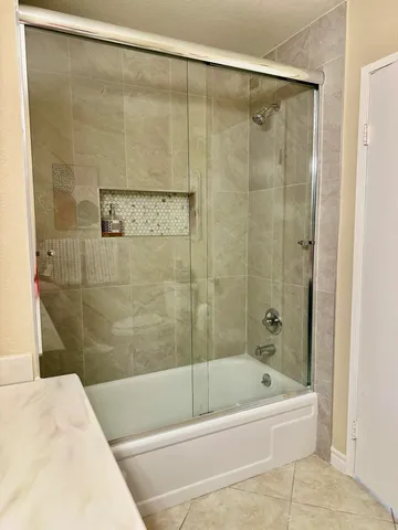 a bathroom with a shower and a bath tub