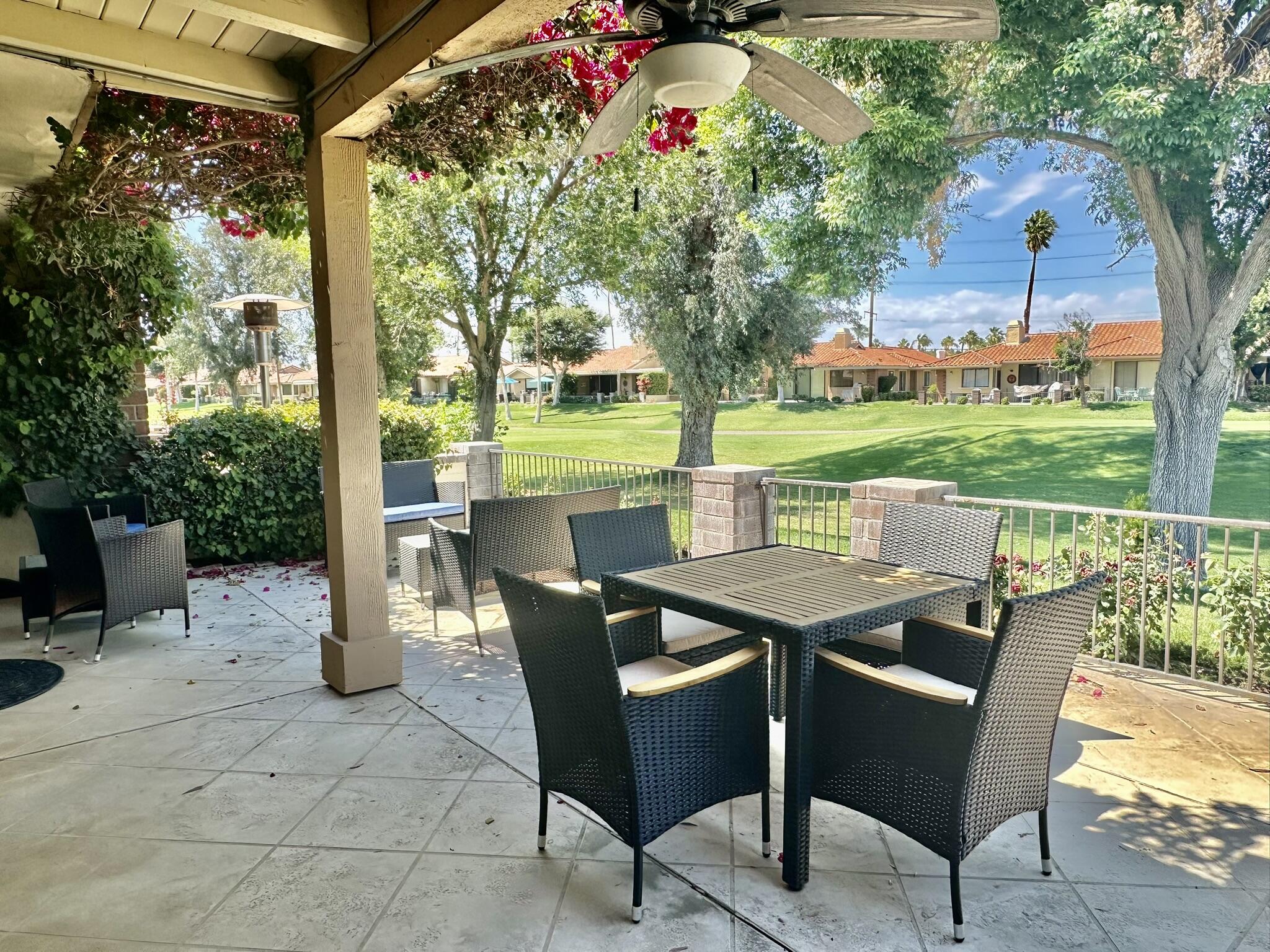336 Villena Way Palm Desert, CA 92260 - Photo 3 of 19 a view of a patio with a table chairs and a backyard