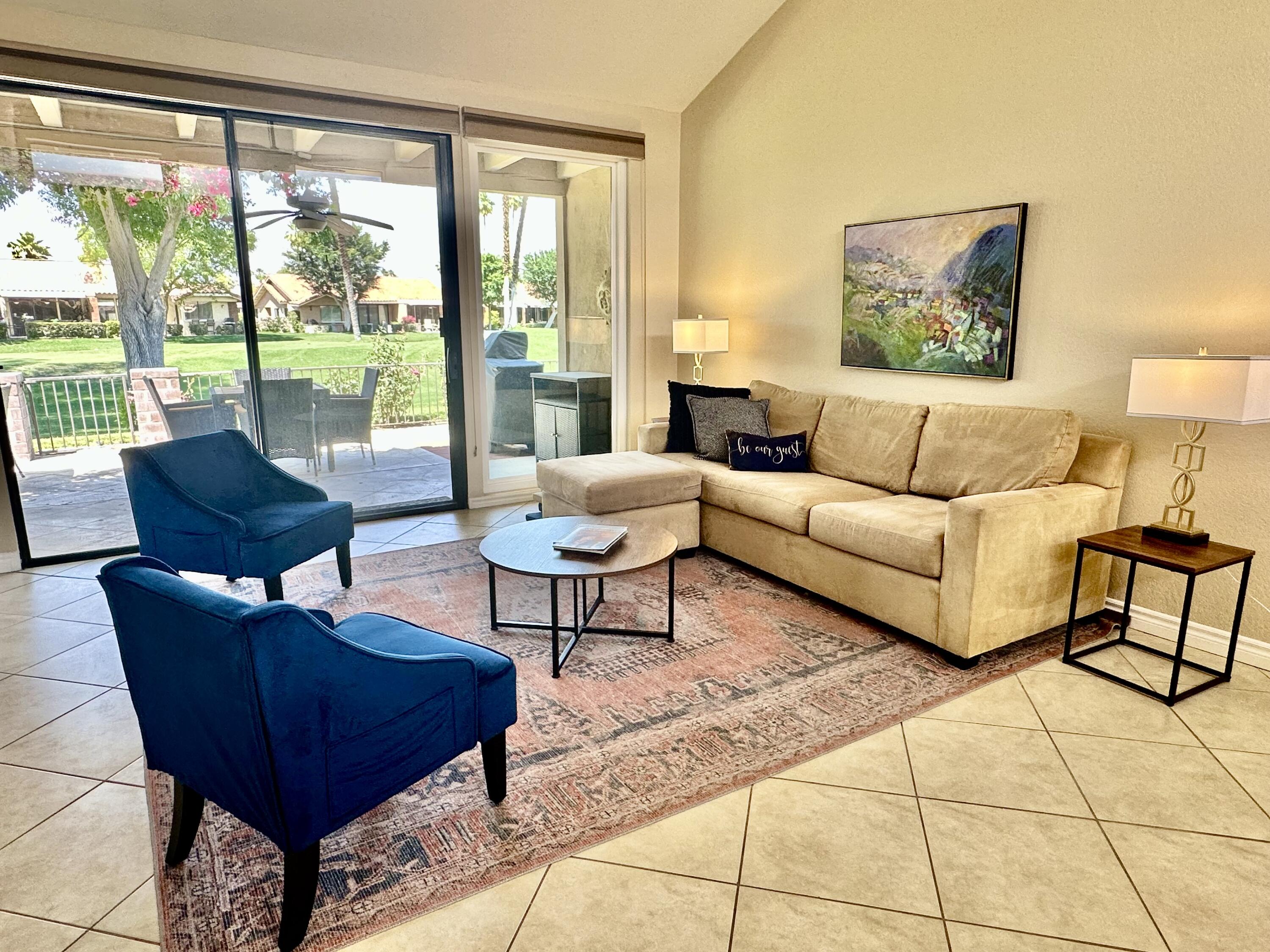 336 Villena Way Palm Desert, CA 92260 - Photo 7 of 19 a living room with furniture and a large window
