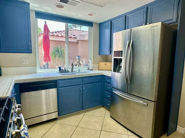 a kitchen with stainless steel appliances a refrigerator and a sink