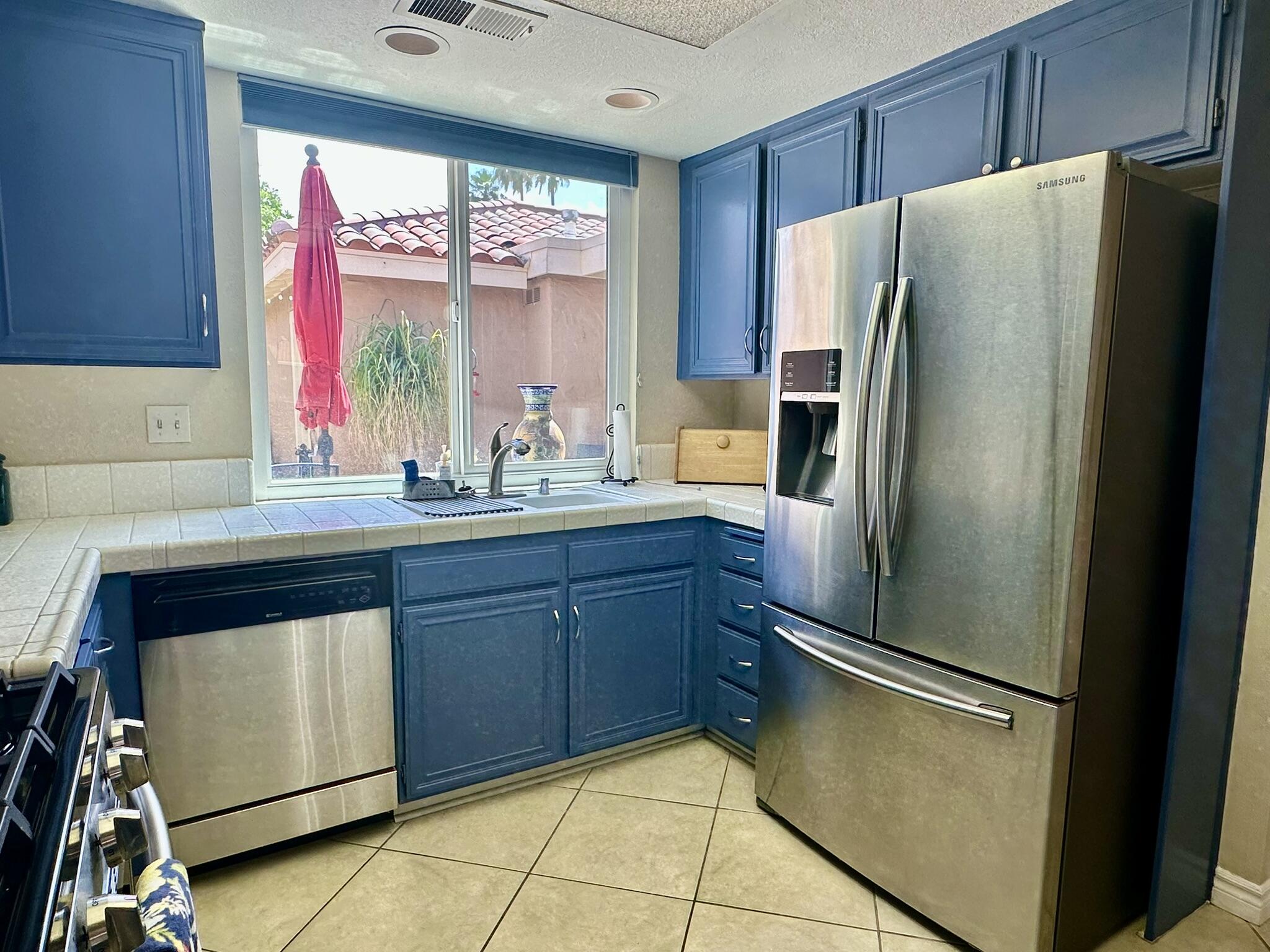 336 Villena Way Palm Desert, CA 92260 - Photo 10 of 19 a kitchen with stainless steel appliances a refrigerator and a sink