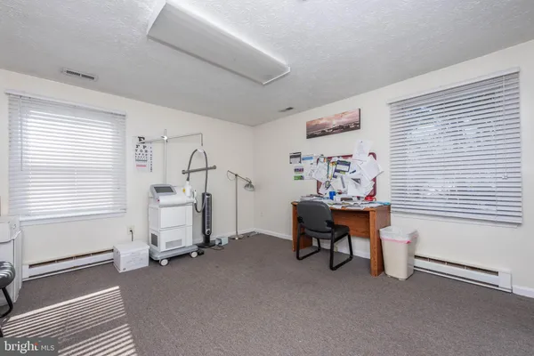 a view of a livingroom with furniture and a window