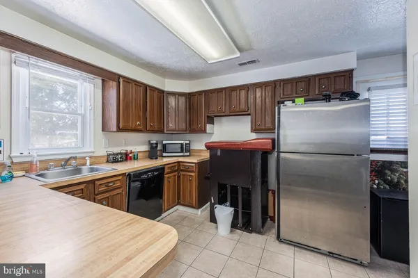 a kitchen with stainless steel appliances granite countertop a refrigerator sink and cabinets