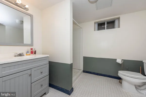 a bathroom with a sink a toilet and vanity
