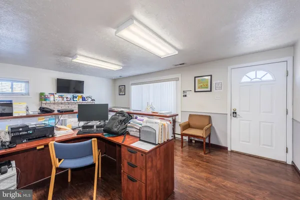 a workspace with furniture and wooden floor
