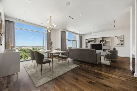 a living room with furniture a rug and a chandelier