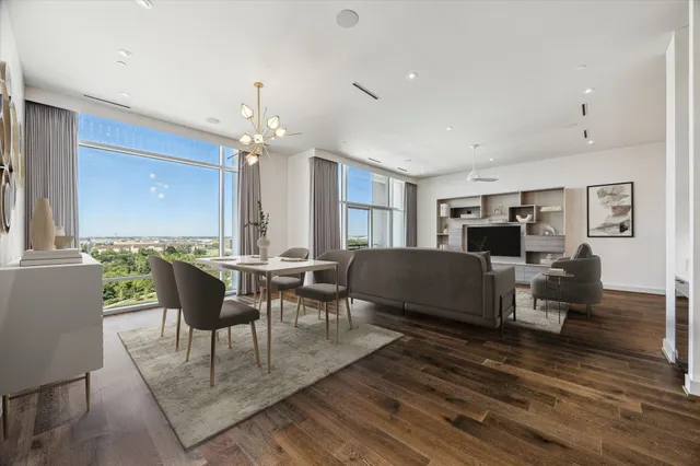 a living room with furniture a rug and a chandelier