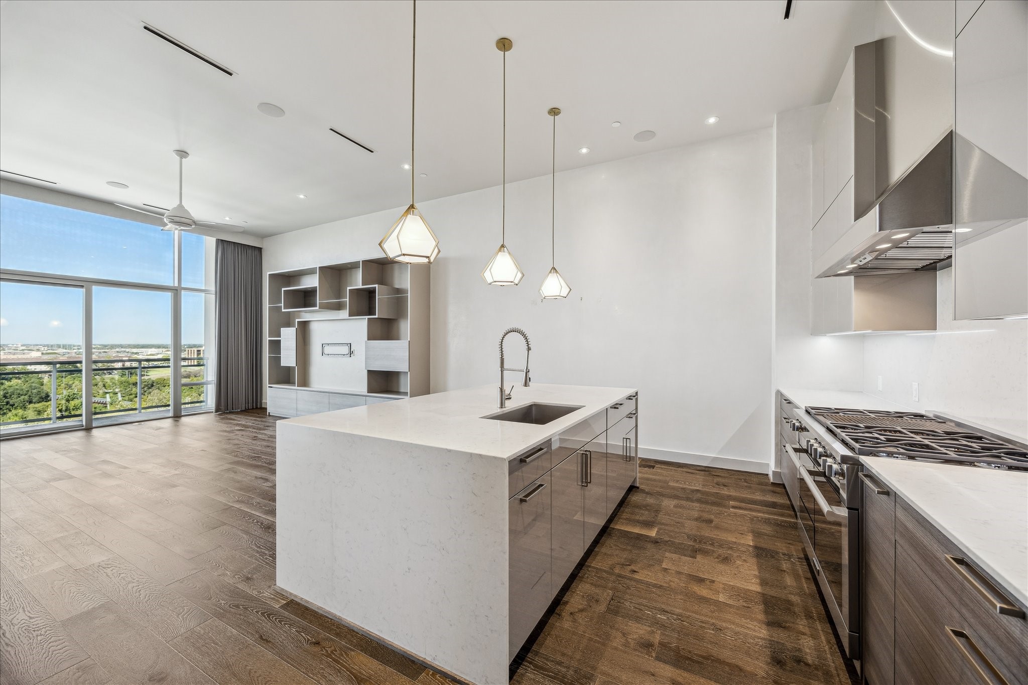 3331 D'Amico Street, Unit 1003 Houston, TX 77019 - Photo 11 of 46 a open kitchen with stainless steel appliances granite countertop a sink a stove and a wooden floors