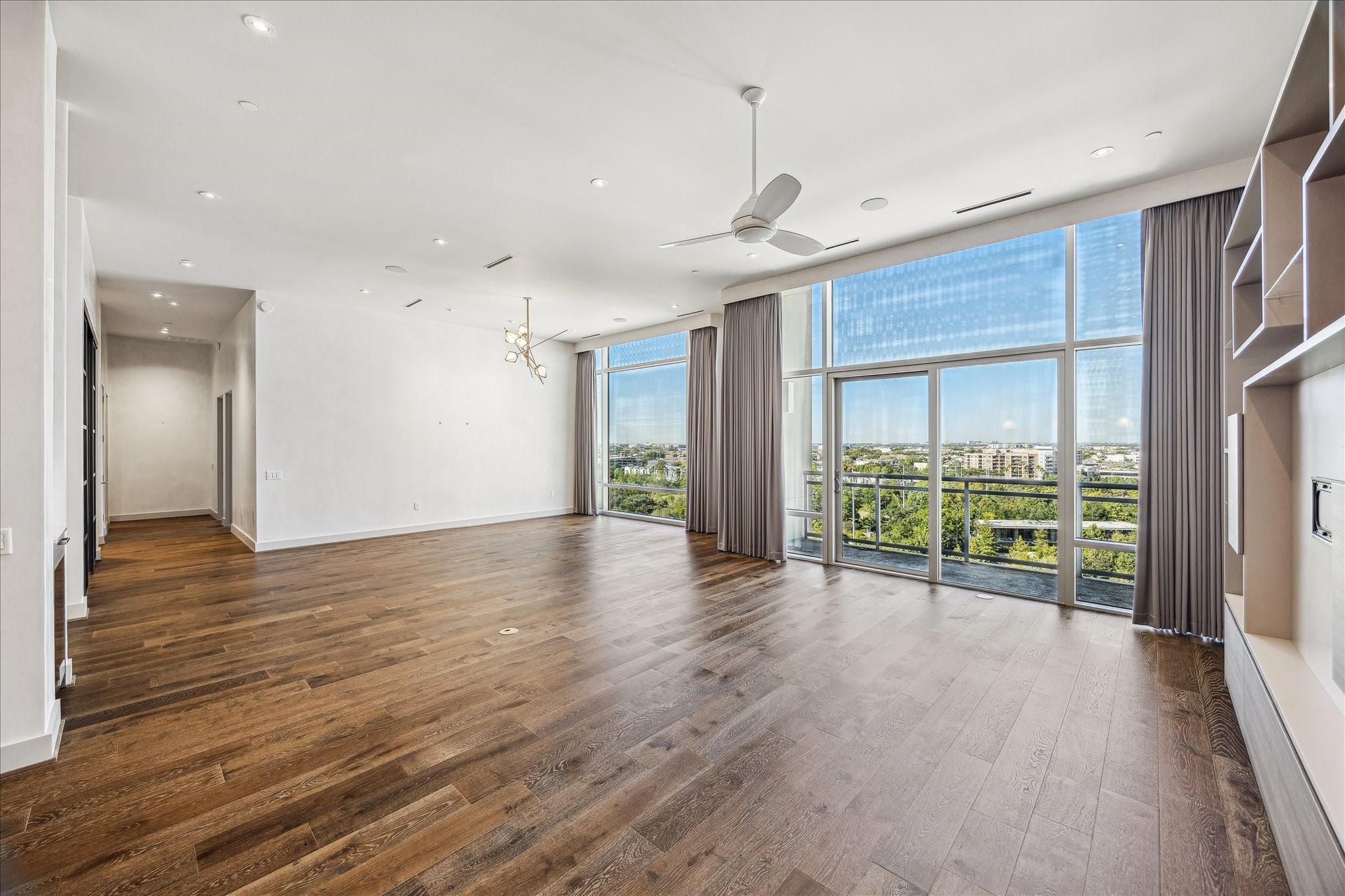 3331 D'Amico Street, Unit 1003 Houston, TX 77019 - Photo 13 of 46 a view of an empty room with wooden floor and a window