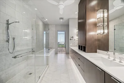 a bathroom with a double vanity sink mirror and shower