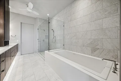 a spacious bathroom with a bathtub and a shower