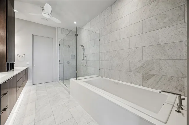 a spacious bathroom with a bathtub and a shower