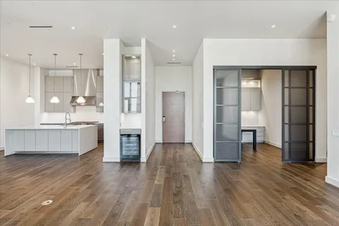 a large kitchen with a lot of counter space and stainless steel appliances