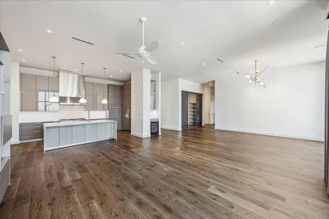 a view of kitchen with kitchen island wooden floor and center island