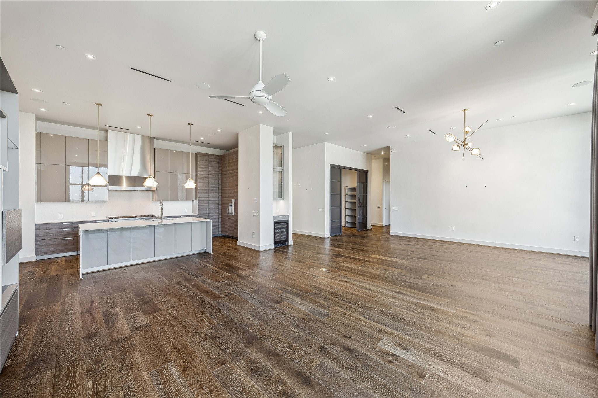 3331 D'Amico Street, Unit 1003 Houston, TX 77019 - Photo 8 of 46 a view of kitchen with kitchen island wooden floor and center island