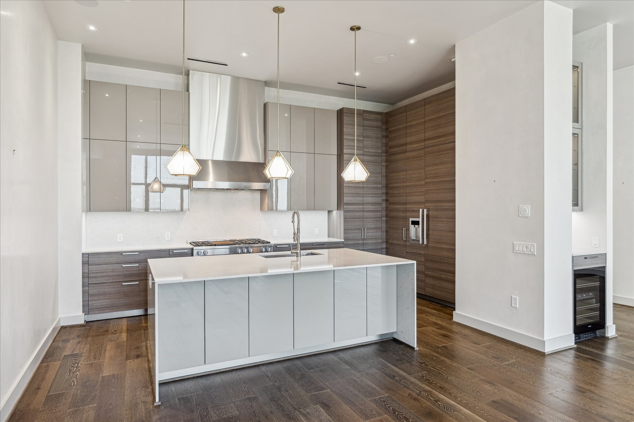 3331 D'Amico Street, Unit 1003 Houston, TX 77019 - Photo 9 of 46 a kitchen with stainless steel appliances granite countertop a sink a stove a refrigerator and island with wooden floor