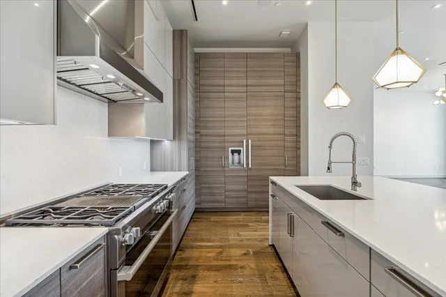 a kitchen that has a sink and a stove