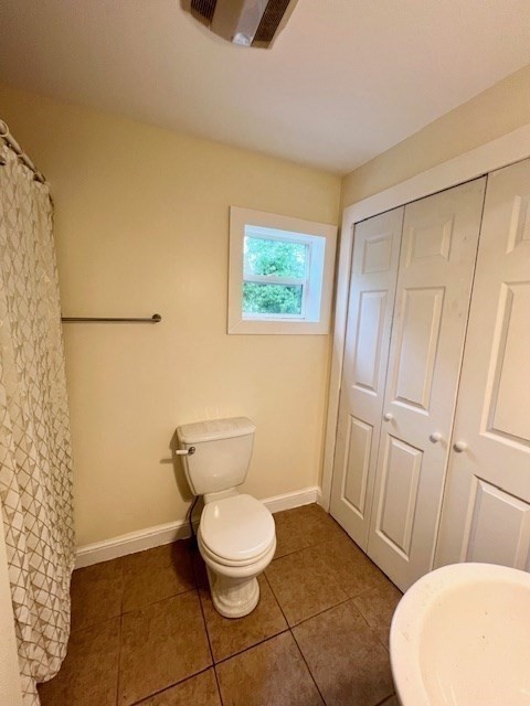 61 Center Street Bridgewater, MA 02324 - Photo 21 of 33 a white toilet sitting next to a bathroom sink and a mirror