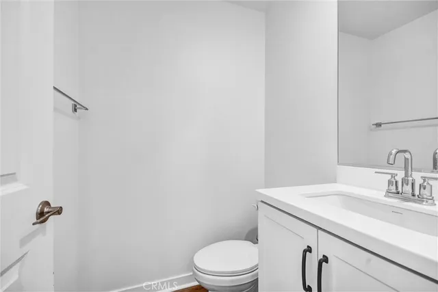 a bathroom with a sink a toilet and vanity