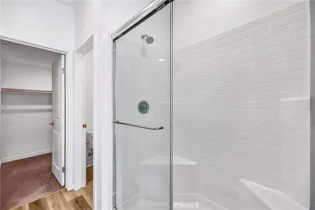 a bathroom with a shower and a glass door