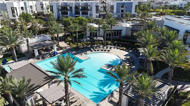 an aerial view of a residential apartment building with a yard