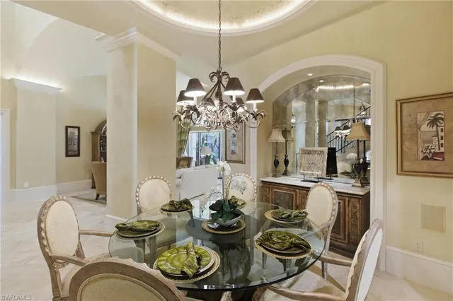 a dining room with furniture and chandelier