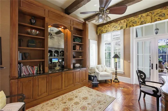 a livingroom with workspace and a window