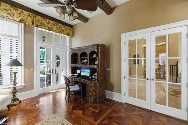 a view of a workspace with furniture and a window