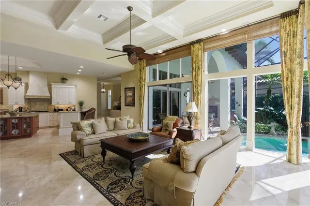a living room with furniture a wooden floor and a chandelier