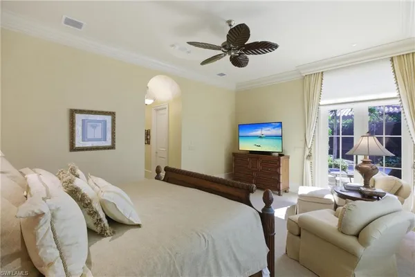 a bedroom with a bed and a chandelier
