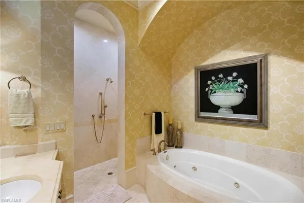 a white bath tub sitting next to a white toilet