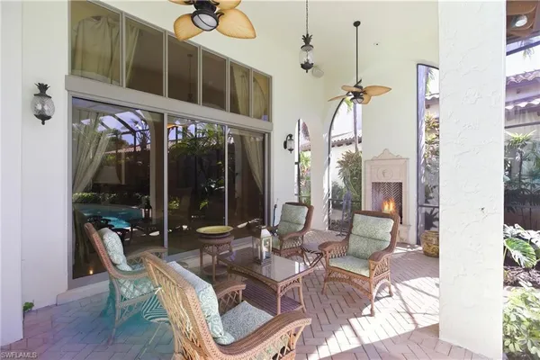 a view of a patio with table and chairs potted plants
